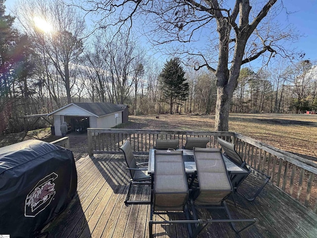 deck featuring an outbuilding, grilling area, and a garage