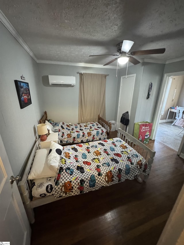 bedroom with ceiling fan, a textured ceiling, hardwood / wood-style flooring, and a wall mounted AC