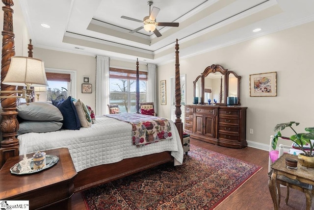 bedroom featuring dark hardwood / wood-style floors, ceiling fan, crown molding, and a raised ceiling