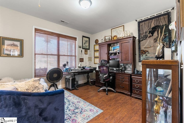 home office with dark hardwood / wood-style flooring