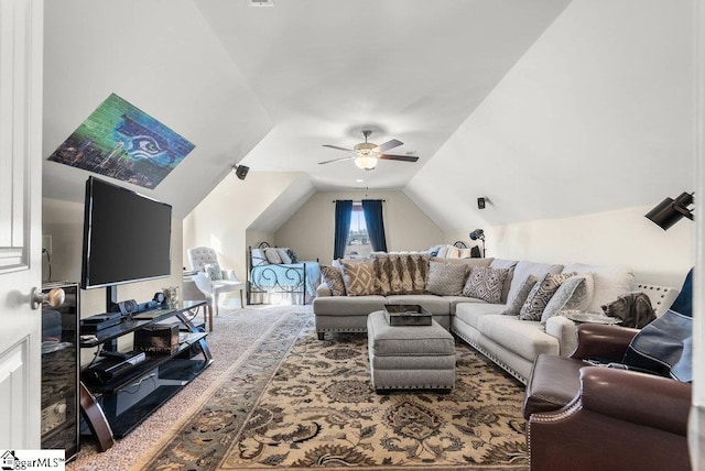 living room featuring vaulted ceiling, ceiling fan, and carpet