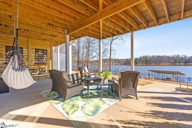 view of patio with a water view and outdoor lounge area