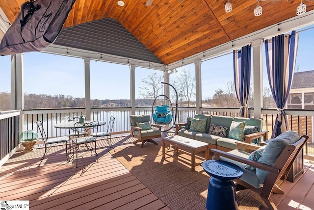 sunroom with vaulted ceiling, wooden ceiling, and a water view