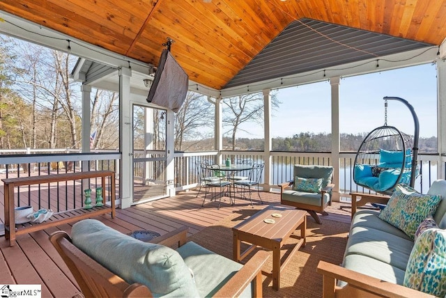 sunroom with a water view, wooden ceiling, a wealth of natural light, and lofted ceiling