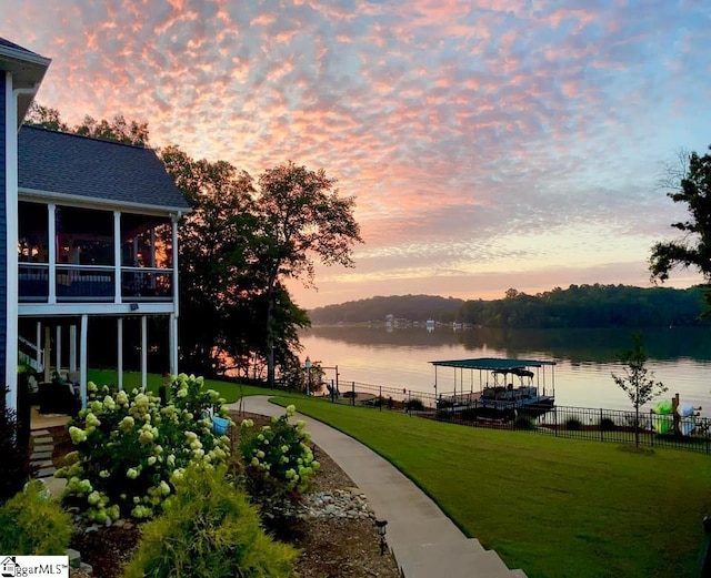 exterior space with a sunroom and a water view