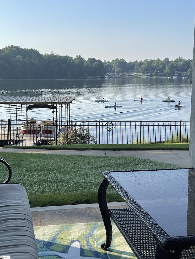 dock area with a water view and a yard