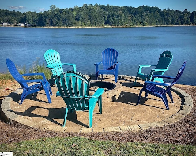 view of patio / terrace with a water view and a fire pit