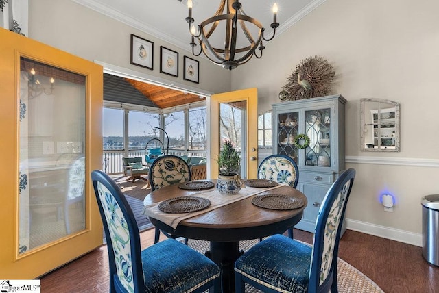 dining area with a notable chandelier, crown molding, and dark hardwood / wood-style floors