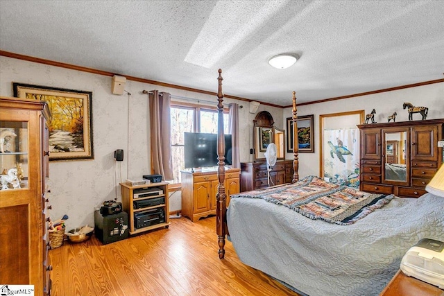 bedroom featuring a textured ceiling, crown molding, and light wood-type flooring