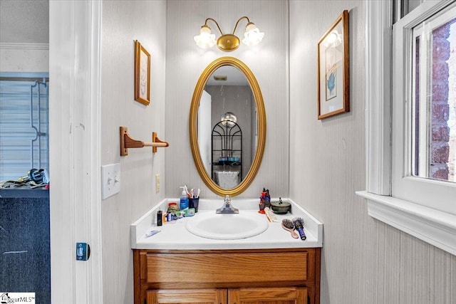 bathroom with a textured ceiling, vanity, and crown molding