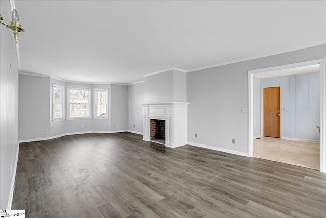 unfurnished living room with a fireplace with flush hearth, baseboards, dark wood-style flooring, and ornamental molding