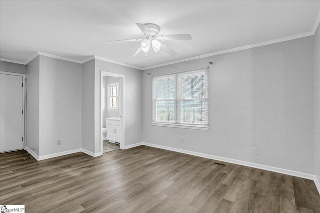 empty room featuring ceiling fan, dark hardwood / wood-style floors, and crown molding