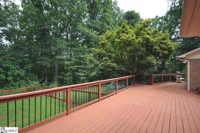 wooden terrace featuring a yard