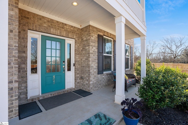 property entrance with a balcony and a porch