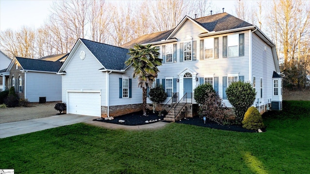 view of front facade featuring a garage, a front yard, and central air condition unit