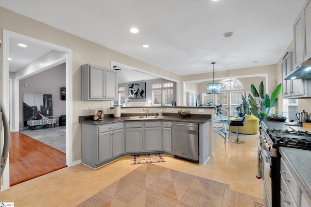 kitchen featuring appliances with stainless steel finishes, gray cabinetry, a chandelier, pendant lighting, and sink