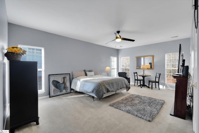 bedroom with ceiling fan and light colored carpet