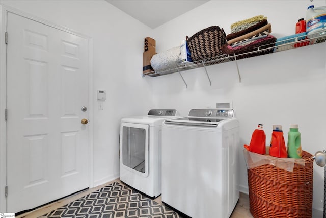 clothes washing area with washer and clothes dryer