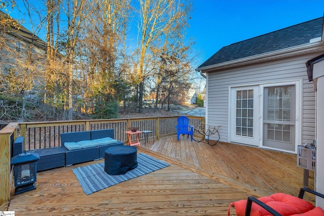 wooden deck with an outdoor living space