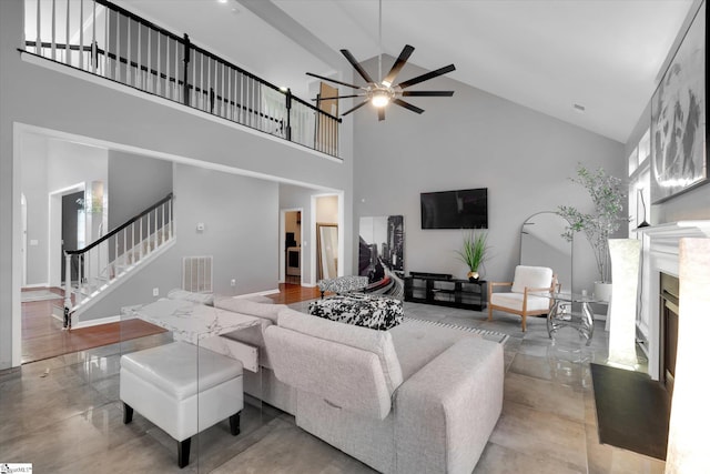 living room with high vaulted ceiling, a high end fireplace, and ceiling fan