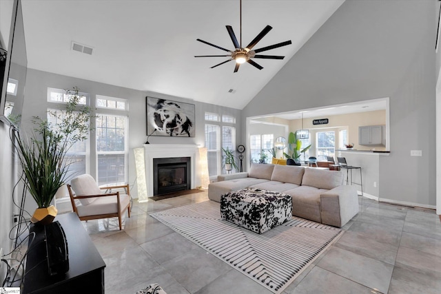 living room with high vaulted ceiling and ceiling fan