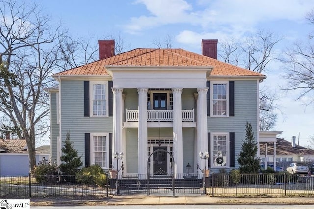 greek revival inspired property with a balcony