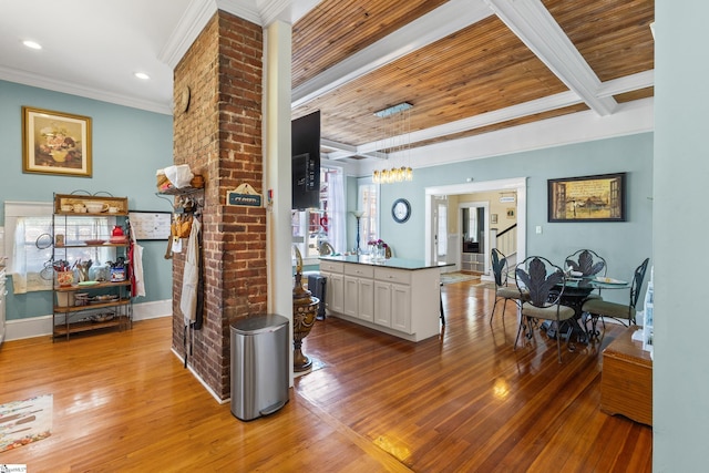 kitchen with light hardwood / wood-style floors, decorative light fixtures, ornamental molding, beam ceiling, and white cabinets