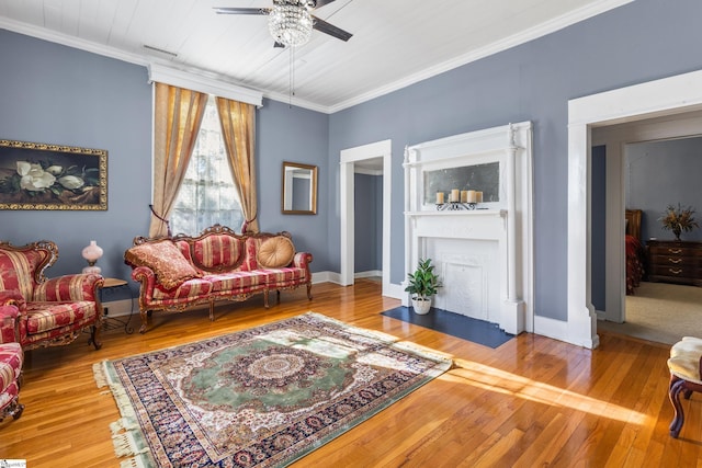 living room with ceiling fan, crown molding, and hardwood / wood-style floors