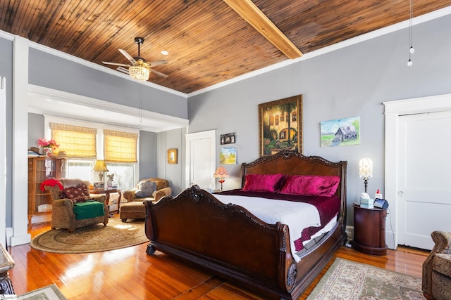 bedroom with ceiling fan, wood-type flooring, and crown molding