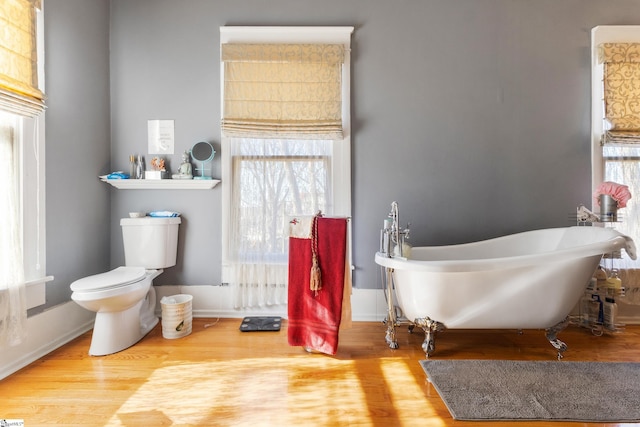 bathroom featuring toilet, a bathtub, and hardwood / wood-style floors