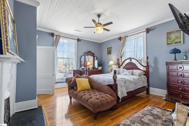 bedroom featuring ceiling fan, hardwood / wood-style floors, ornamental molding, and wood ceiling