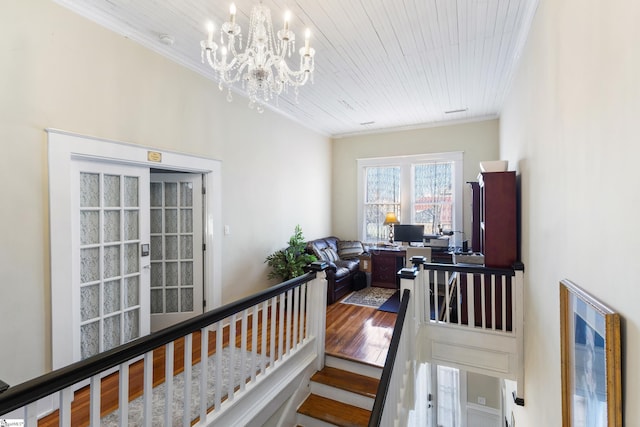 office space with hardwood / wood-style flooring, wooden ceiling, ornamental molding, and a chandelier