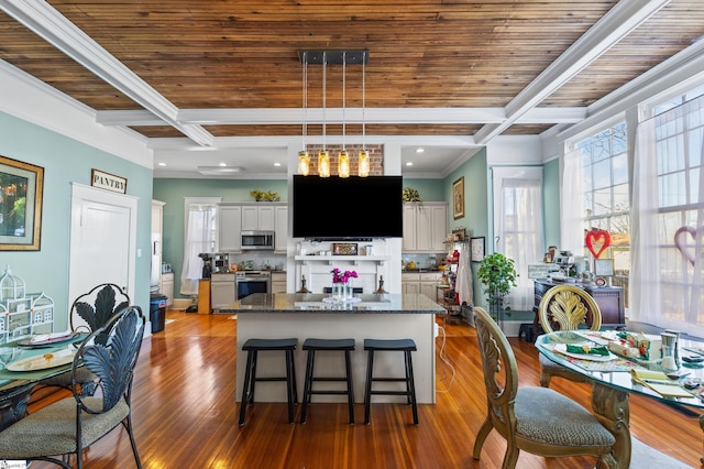 kitchen with decorative backsplash, dark stone counters, stainless steel appliances, and white cabinetry