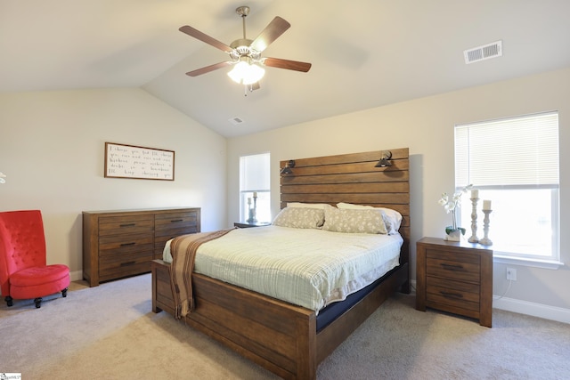 bedroom with ceiling fan, light carpet, and vaulted ceiling