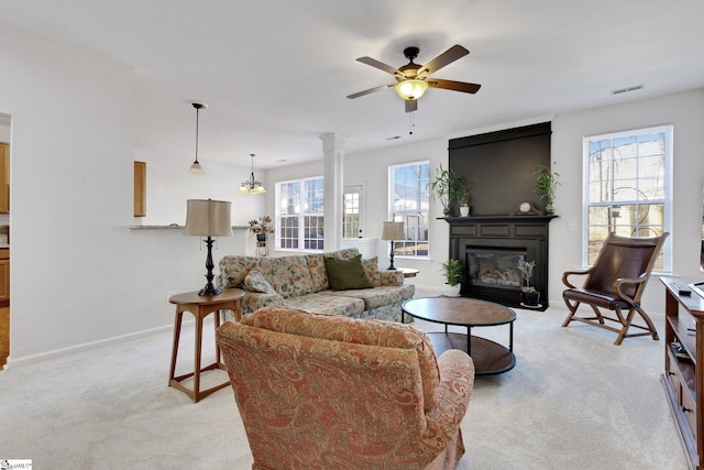 living room with light carpet, a large fireplace, and ceiling fan