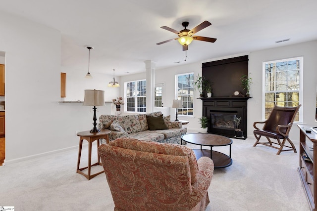 living room with ceiling fan, a fireplace, and light carpet