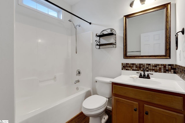 full bathroom with vanity, backsplash, shower / tub combination, and toilet