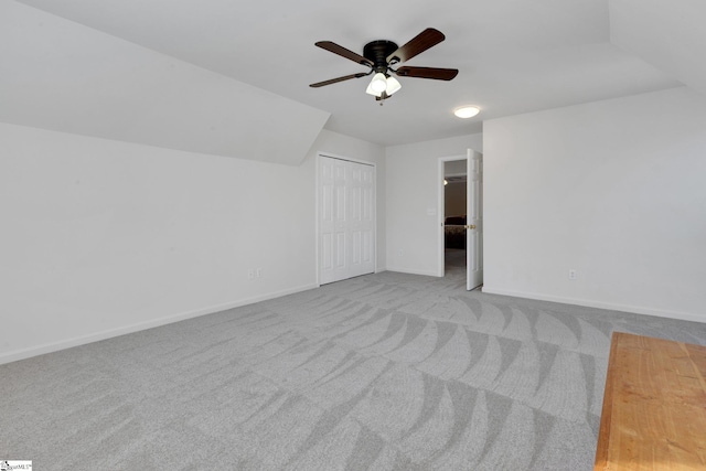 bonus room with light carpet and ceiling fan