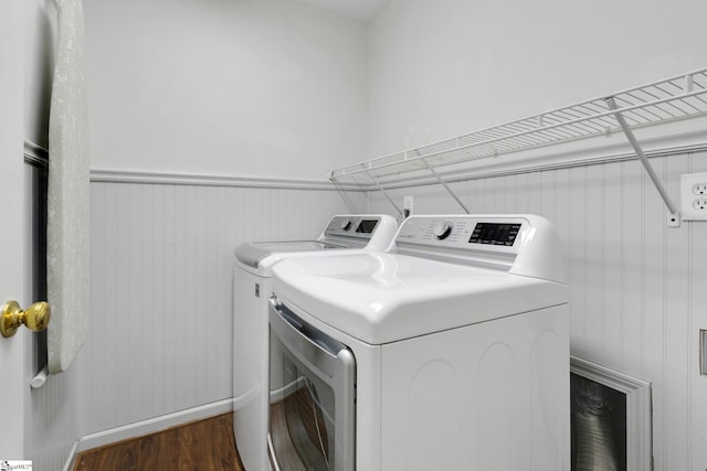 washroom with washer and dryer and dark wood-type flooring