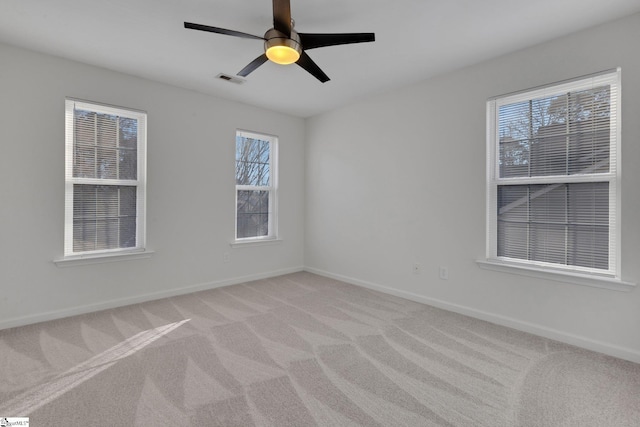 empty room with light colored carpet and ceiling fan