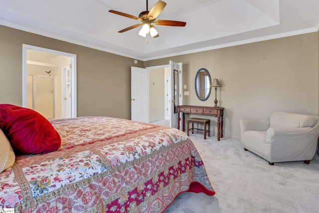 bedroom with ornamental molding, light colored carpet, ceiling fan, and a tray ceiling