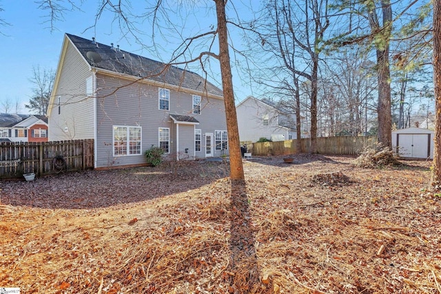 rear view of house featuring a storage unit