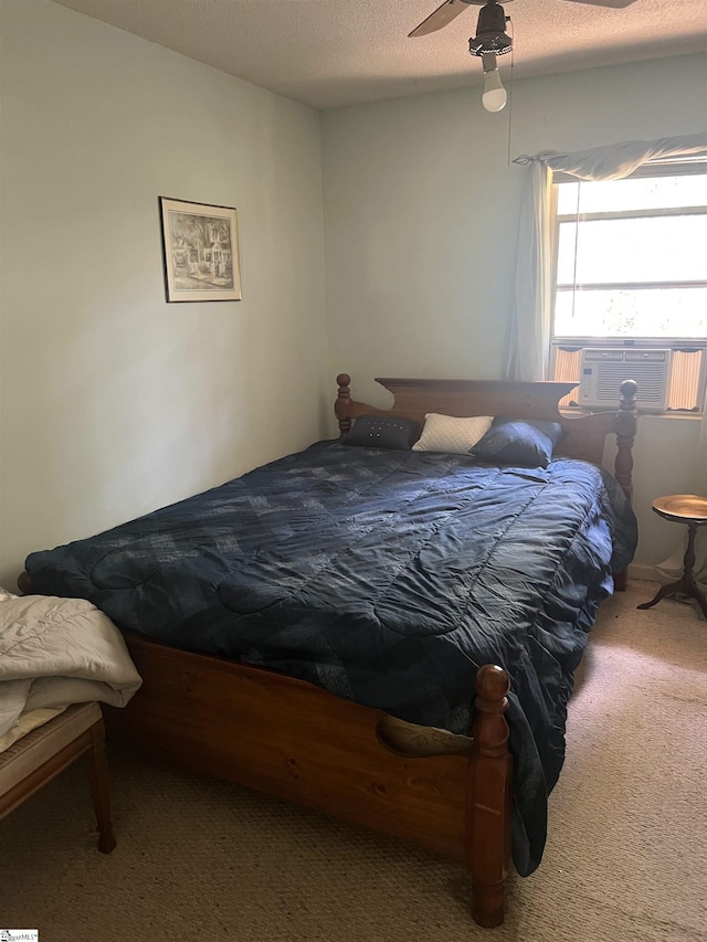 carpeted bedroom featuring a textured ceiling, ceiling fan, and cooling unit