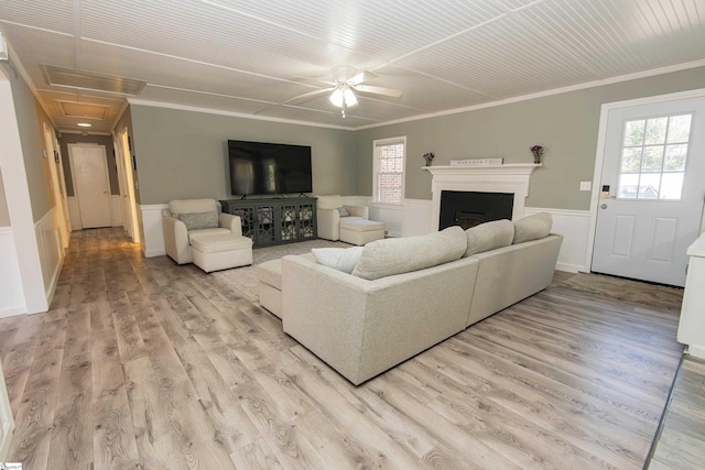 living room with ceiling fan, light hardwood / wood-style flooring, and crown molding