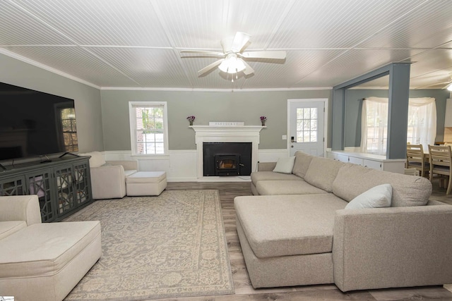 living room featuring ceiling fan, ornamental molding, and hardwood / wood-style flooring