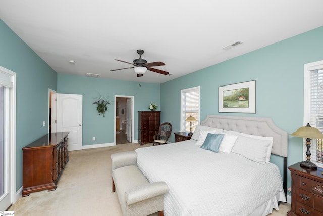 carpeted bedroom with ceiling fan and connected bathroom