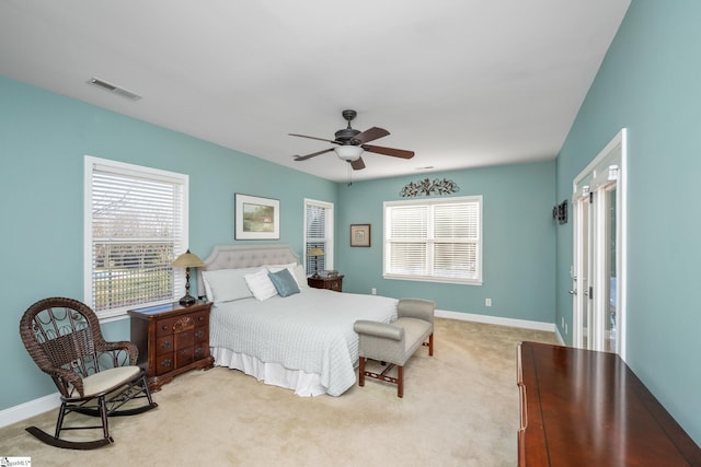 bedroom with ceiling fan and light colored carpet