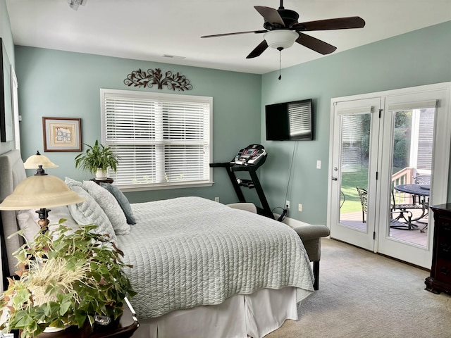 carpeted bedroom with ceiling fan and access to exterior