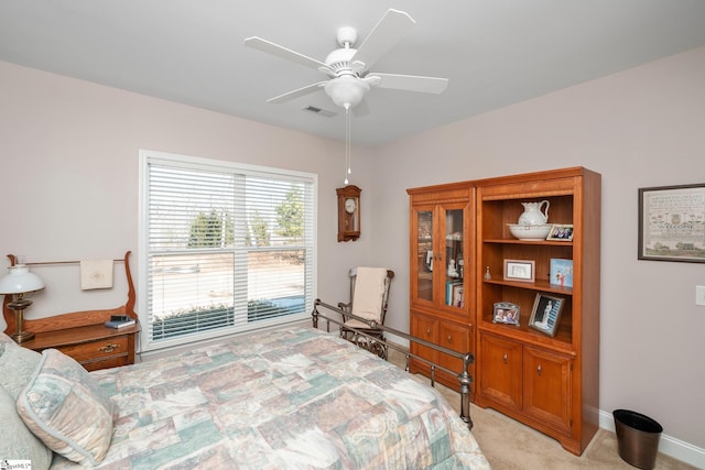 bedroom featuring light carpet and ceiling fan