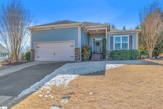 view of front of house with aphalt driveway, stone siding, roof with shingles, and an attached garage